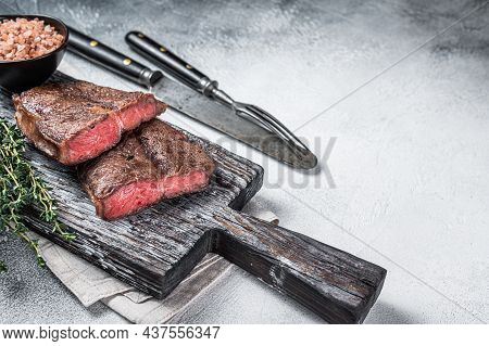 Roasted Shoulder Top Blade Or Flat Iron Beef Meat Steaks On Wooden Board. White Background. Top View
