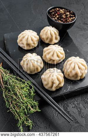 Chinese Baozi Dumplings On A Marble Board. Black Background. Top View