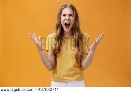 Studio Shot Of Young Woman During Argument Losing Temper Standing Pressured And Pissed Yelling Out L