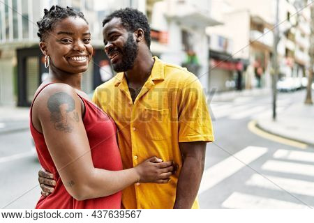 Young afircan american couple smiling happy and hugging at the city.