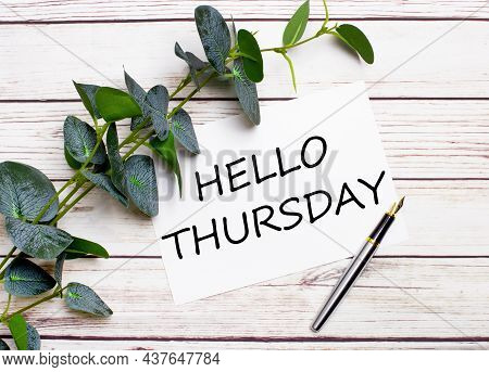 On A Light Wooden Table, There Is A Eucalyptus Branch, A Fountain Pen And A Sheet Of Paper With The 