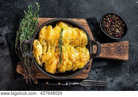 Potato Gratin Dauphinois In A Pan. Black Background. Top View