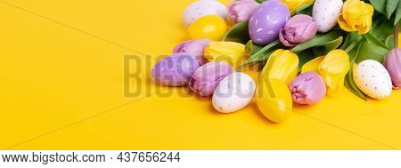 Easter Composition. Multicolored Easter Eggs And Tulips On Yellow Background. Easter Concept. Copy S