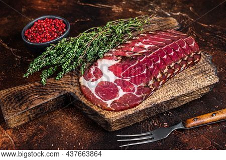 Sliced Cured Coppa Ham On Wooden Board With Thyme. Dark Background. Top View