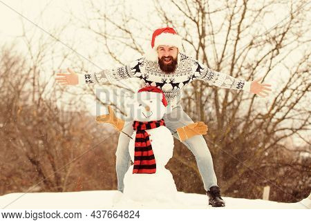 Fun And Entertainment. Winter Vacation. Man Made Snowman. Hipster With Beard Outdoors. Man With Sant