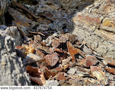 Geodesy. Stone Texture. The Rock Is Brown And Red. Mineral Background. Design From Natural Materials