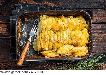 Potato Casserole Gratin Dauphinois In A Baking Dish. Dark Wooden Background. Top View
