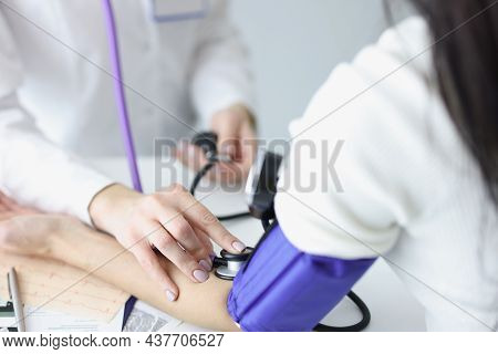 Close-up Of Female Therapist Hands Holding Tonometer And Checking Blood Pressure Of Woman Patient. M