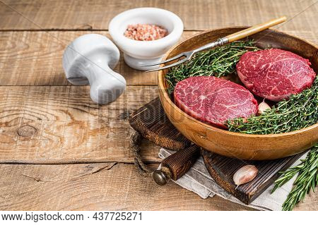 Fresh Meat Fillet Mignon Steaks From Beef Tenderloin. Wooden Background. Top View. Copy Space