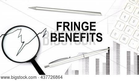 Fringe Benefits Text On The Document With Pen,graph And Magnifier,calculator