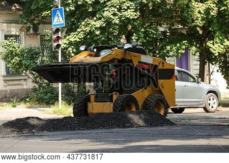 Modern Skid Loader On City Street. Road Repair Service