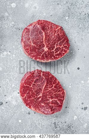 Raw Fillet Mignon Beef Steaks On A Butcher Board. Gray Background. Top View