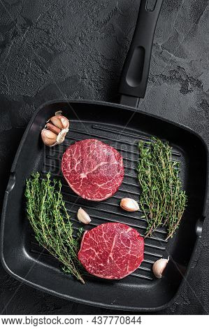 Tenderloin Raw Fillet Mignon Beef Steaks On A Pan. Black Background. Top View