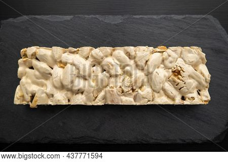 Top View Of Christmas Turron Over Black Background.