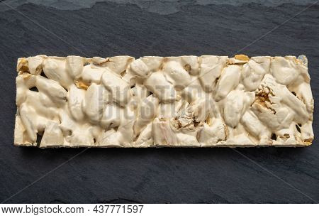 Top View Of Christmas Turron Over Black Background.