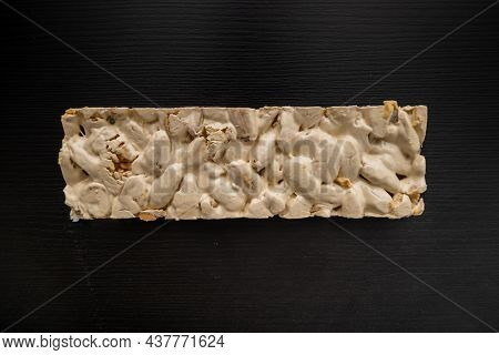 Top View Of Christmas Turron Over Black Background.