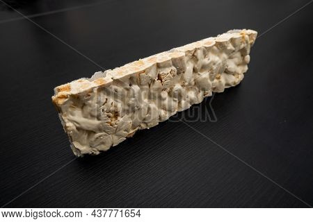 Perspective View Of Christmas Turron Over Black Background.