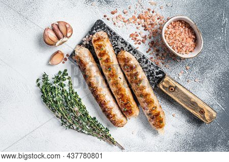 Grilled Bockwurst And Bratwurst Meat Sausages On A Cleaver. White Background. Top View