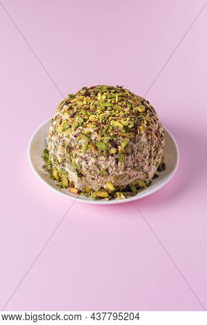 Sesame Halva With Pistachios Nuts On White Plate On Pink Paper Background. High Angle View. Copy Spa