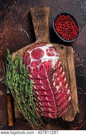 Sliced Cured Coppa Ham On Wooden Board With Thyme. Dark Background. Top View
