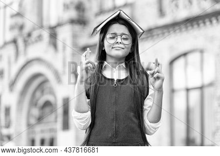 Crossing Fingers For Luck. Little Geek Make Wish Outdoors. Small Child Hold Book On Head. Knowledge 