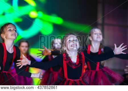 Little Girls Are Performing A Dance Number. Dance For Helovinna In Red Suits. Girl Dancing. Emotiona