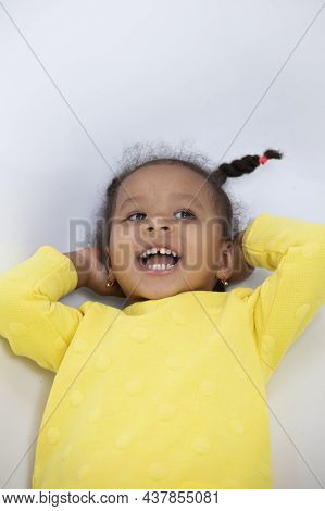 Portrait Of A Funny Little African American Girl With Pigtails.