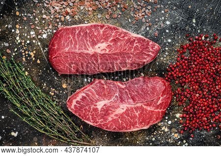 Raw Shoulder Top Blade Cuts, Beef Meat Steaks. Brown Background. Top View