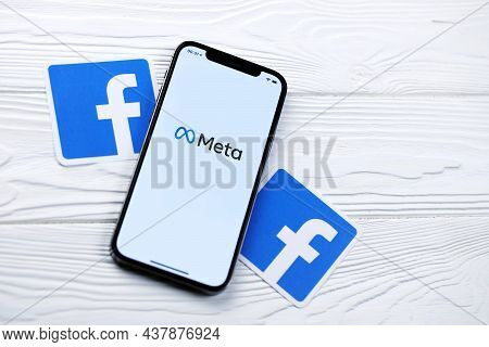 Kharkov, Ukraine - October 29, 2021: Iphone 12 Pro With Meta Or Metaverse Logo Lies On Wooden Table