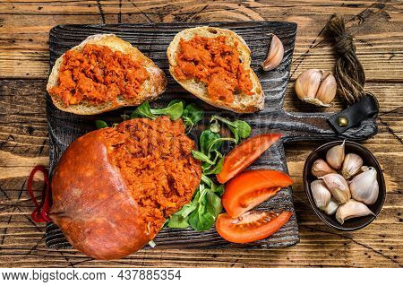 Tapaa Sandwichs With Sobrassada Cured Pork Meat Sausage And Tomato On A Wooden Cutting Board. Wooden