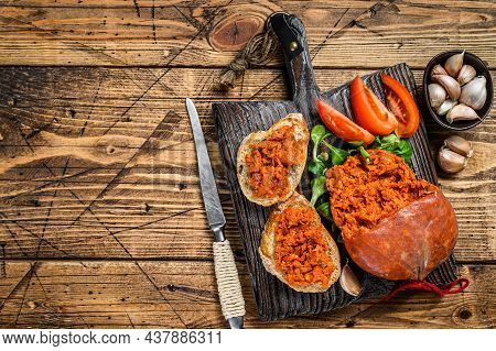 Tapaa Sandwichs With Sobrassada Cured Pork Meat Sausage And Tomato On A Wooden Cutting Board. Wooden