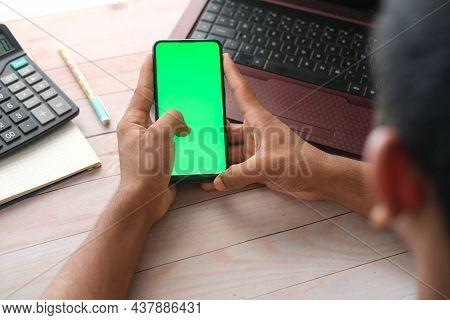 Top View Of Man Hand Using Smart Phone On Office Desk