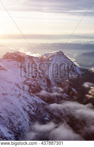 Aerial View Of Canadian Rocky Mountains With Snow On Top During Fall Season Sunset. Nature Landscape