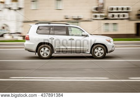 Toyota Land Cruiser 200 Suv Moving Fast On The Street Of Moscow. Silver Shiny Full-size Luxury Cross