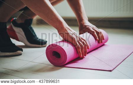 Man Laying Down His Yoga Mat. Preparing For A Complex Of Morning Exercises. Body Care