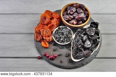 Dried Fruits. Dried Apricots, Prunes, Raisins, Dates. Proper Nutrition. Close-up. Top View. On A Gra