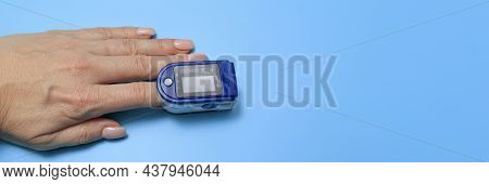 Senior Woman Using Pulse Oximeter, Measuring Oxygen Saturation. Human Hand Pulse Oximeter Used To Me