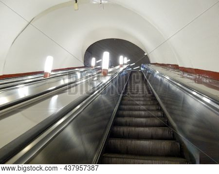 The Escalator Lifts Up The Tunnel With Lanterns All In White And Light Tone