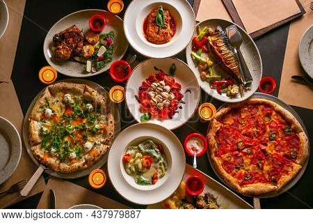 Top Down View On Enormous Buffet Of Delicious Freshly Prepared European Cuisine And Pizza With Empty