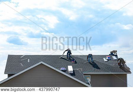 4 Construction Workers Fixing Roof Against Clouds Blue Sky, Install Shingles At The Top Of The House
