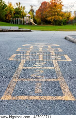 Schoolyard And Playground For Elementary Students In Evening In Fall. Selective Focus On Hopscotch. 