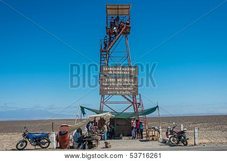 NAZCA, PERU - JULY 31: people at the Nazca lines observation tower in the peruvian coast at Ica Peru on july 31, 2013. The Nazca Lines are a series of ancient geoglyphs located in the Nazca Desert.