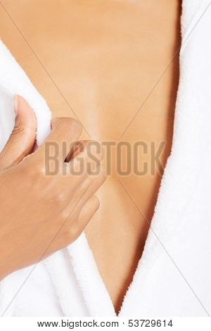 Female's ches coevered with towel. Closeup. Bodypart.