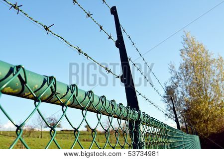 Fence with barbed wire