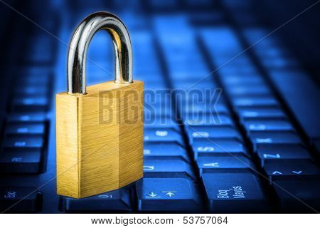 Locked padlock om a glowing blue computer keyboard useful to illustrate data security