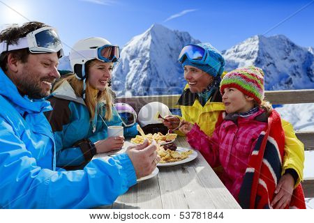 Winter, ski - skiers enjoying lunch in winter mountains