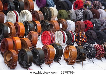 Many kinds of belts on white baskground