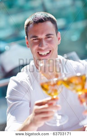 happy young couple having lanch at beautiful restaurant on by the sea on  beach