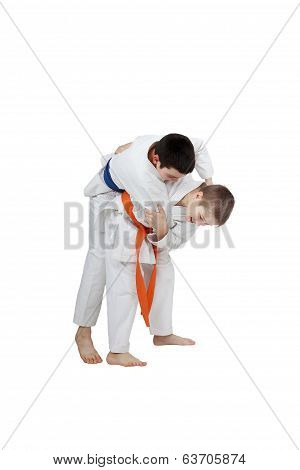 Capture for throw is performing athlete  with orange belt