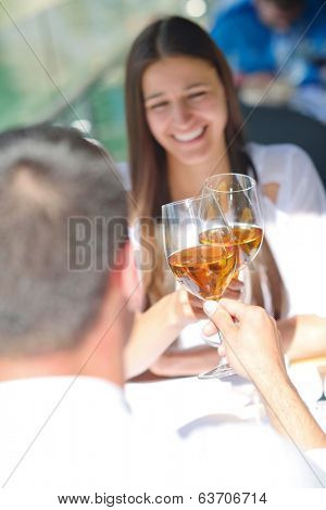 happy young couple having lanch at beautiful restaurant on by the sea on  beach